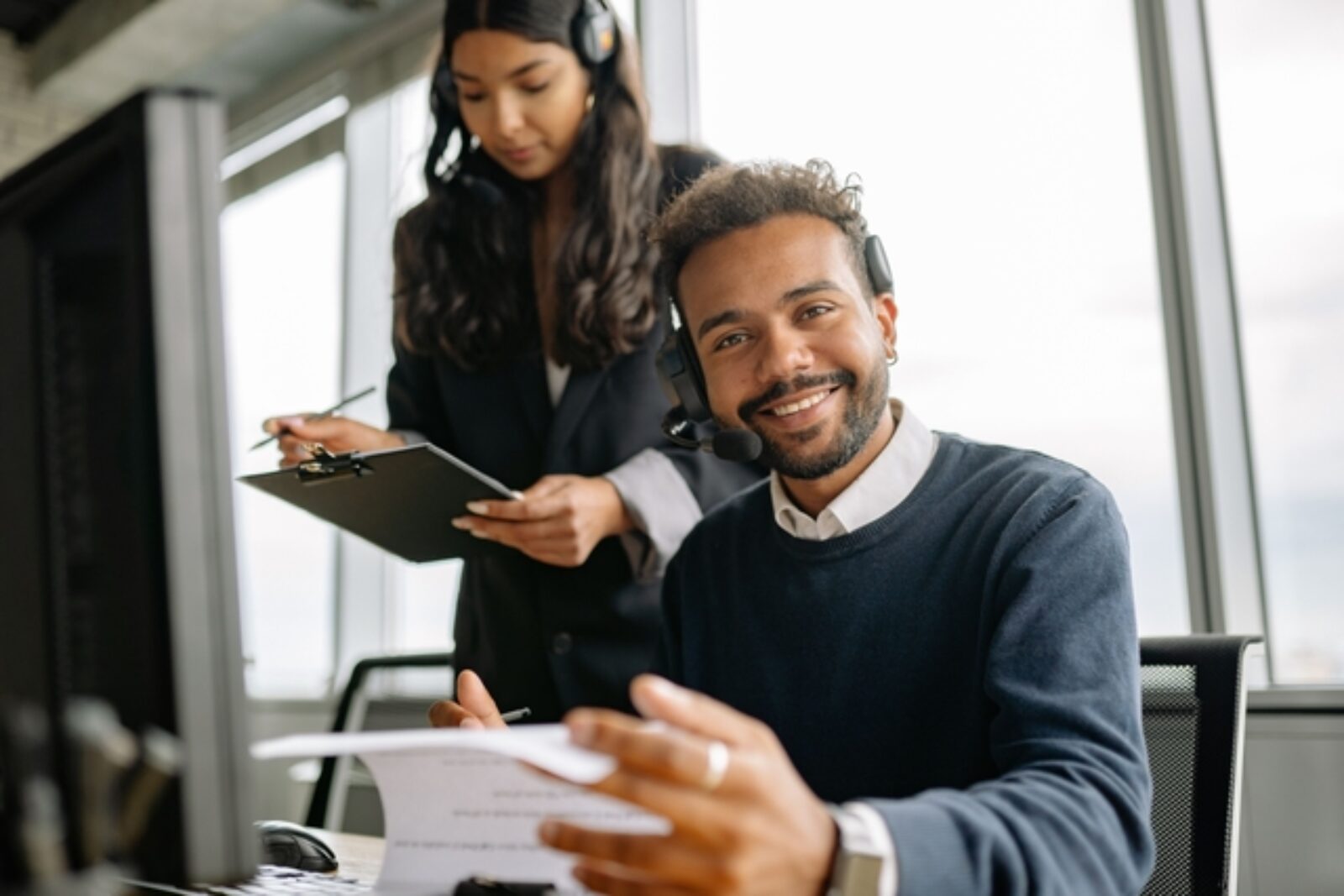 Business owner reviewing business technology systems with an IT professional to improve security, efficiency, and support future growth