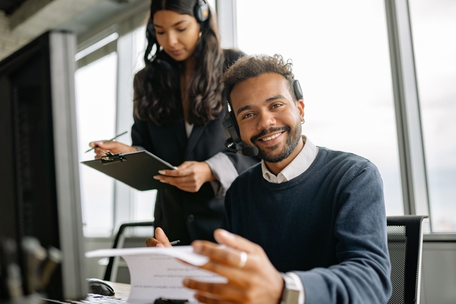 Business owner reviewing business technology systems with an IT professional to improve security, efficiency, and support future growth