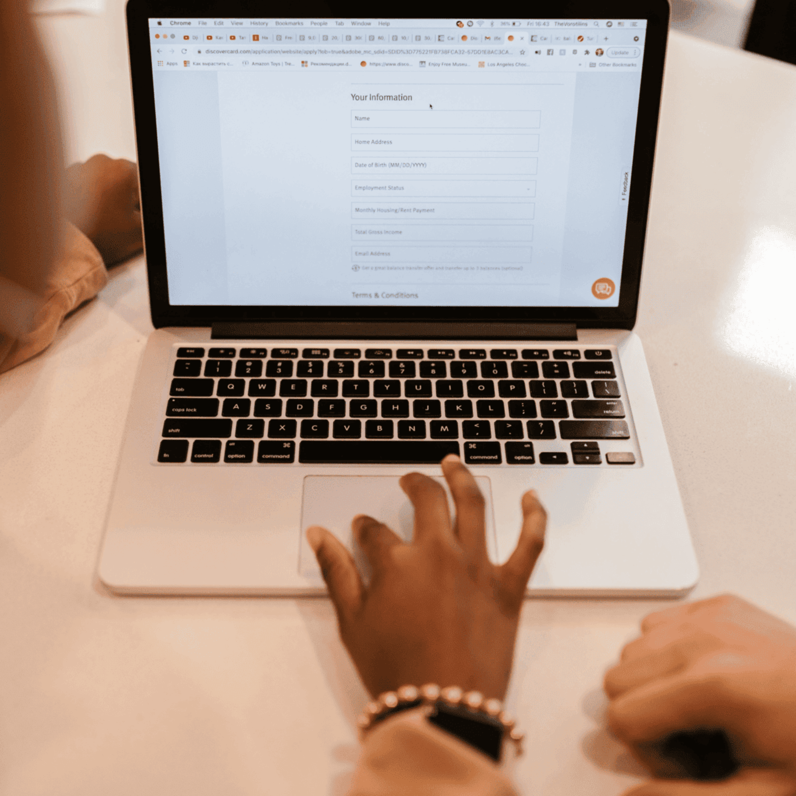 person standing overa laptop as they fill in an online form; to illustrate the importance of customer information protection
